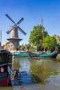 Windmill and historic ships in the harbor of Gouda Royalty Free Stock Photo