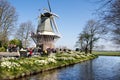 Windmill, canal, visitors in Keukenhof Garden