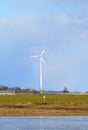 Windmill in Latvia - view from ploughland with frozen waters.