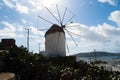 Windmill in Mykonos, Greece. Windmill on mountain landscape by sea. Whitewashed building with sail and straw roof with Royalty Free Stock Photo