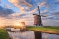 Windmill near the water canal at sunrise in Netherlands Royalty Free Stock Photo