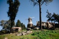 Windmill with old rock castle. red tile roof and string lights. Modern windmill. Country side on a bright summer day