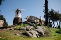 Wind mill with old rock castle. red tile roof and string lights. Modern windmill. Country side on a bright summer day