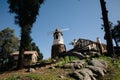 Windmill with old rock castle. red tile roof and string lights. Modern windmill. Country side on a bright summer day