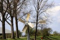 Windmill old style between flower bulb fields in Goeree Royalty Free Stock Photo