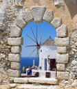 Windmill through an old Venetian window