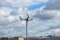 The windmill over the roofs of houses Royalty Free Stock Photo