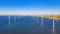 windmill park with a blue sky on a sunny day in the Netherlands, biggest windmill park in the ocean