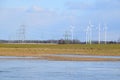 Windmill park in Latvia - view from ploughland with frozen waters.