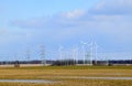 Windmill park in Latvia - view from ploughland with frozen waters.