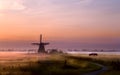 Windmill on pasture at sunrise Royalty Free Stock Photo