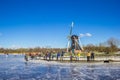 Windmill and people getting ready to skate at the Paterswoldse Meer lake in Groningen