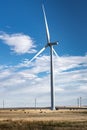 Windmill producing clean energy on an agriculture field with cattle grazing