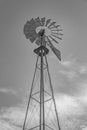 Windmill Pump in Grayscale against Light Sky and White Clouds Royalty Free Stock Photo