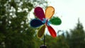 Windmill rotate motion. Colorful weather vane on natural background. air vane on the move