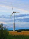 Windmill on rural field in the sunset. Wind turbines farm