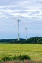 Windmill on rural field in the sunset. Wind turbines farm. Royalty Free Stock Photo