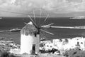 Windmill on seascape in Mykonos, Greece. Windmill on mountain by sea on sky. Whitewashed building with sail and straw Royalty Free Stock Photo