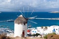 Windmill on seascape in Mykonos, Greece. Windmill on mountain by sea on sky. Whitewashed building with sail and straw Royalty Free Stock Photo