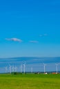 Windmill set.Green energy.Wind generator and home in green field.Windmills on blue sky background.renewable energy.