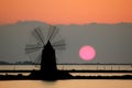 Windmill in a Sicilian saline Royalty Free Stock Photo
