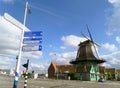 Windmill and Signpost on the Sidewalk of Zaanstad, Historic site in Netherlands