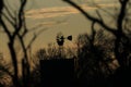 Windmill Silhouette at Sunset with clouds and trees Royalty Free Stock Photo