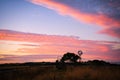 Windmill sunset at an Australian farm. The red sky Royalty Free Stock Photo