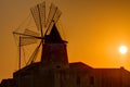 Windmill at sunset at the saltpans of Marsala Royalty Free Stock Photo