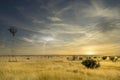 Windmill in a Texas field along Route 66 with a storm approaching Royalty Free Stock Photo