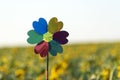 Windmill toy on yellow field background. Alternative energy concept Royalty Free Stock Photo