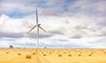 Windmill turbine in a agricultural landscape with fields and meadows.