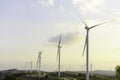 Windmill turbine farm for electricity generation on landscape mountain at sunset sky