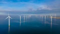 Windmill turbines at sea seen from a drone aerial view from above at a huge windmill park Royalty Free Stock Photo