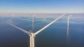 Windmill turbines at sea seen from a drone aerial view from above at a huge windmill park Royalty Free Stock Photo