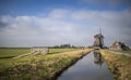 Windmill in a typical Dutch landscape Royalty Free Stock Photo