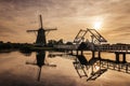 Windmill village Kinderdijk Netherlands, Sunset at the lake by the Dutch wind mill village with wooden windmills