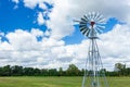 Windmill water pump in a green grass field - Robbins Preserve, Davie, Florida, USA