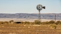 Windmill and water storage tank along Highway 90 just outside of Marfa, Texas. Royalty Free Stock Photo