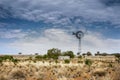 Windmill and watering point on red earth on a remote outback sheep station in far western New South Wales, Australia