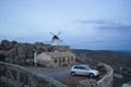 Windmill and white and dirty car near from a house in Los Yebenes, a small town in Toledo, Castile La Mancha, Spain