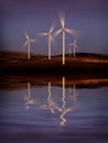 Windmill Wind Turbine Spinning in Wind at Sunset or Sunrise