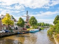 Windmill and bridge over canal in historic old town of Dokkum, F Royalty Free Stock Photo