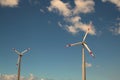 Windmills against bright blue sky