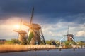 Windmills against cloudy sky at sunset in Kinderdijk, Netherland Royalty Free Stock Photo