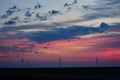 Windmills against a rainbow evening sky