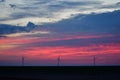 Windmills against a rainbow evening sky Royalty Free Stock Photo