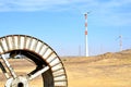 Windmills in the backdrop of a winding wheel on the way to Sam Sand Dunes Thar Desert from Jaisalmer, Rajasthan, India. The