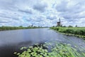 Windmills on a canal with dramatic shaped clouds