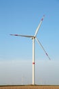 Windmills for electric power production on a sunny day. Vertical photo Royalty Free Stock Photo